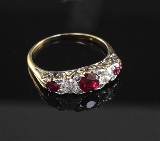 An early 20th century gold, ruby and diamond graduated five stone half hoop ring, size Q.